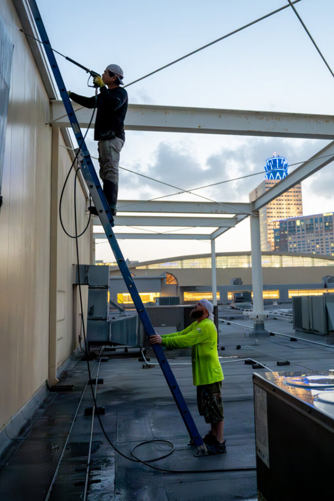 Commercial building exterior pressure washing by Painting Professionals, Inc. in Houston, TX