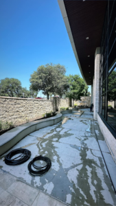 Pressure washing a commercial building exterior patio in San Antonio, TX, by RWD Construction.
