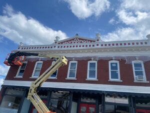 Workers in a JLG lift performing exterior renovation on a commercial building facade by Usa Construction of Danbury LLC in Danbury, CT.