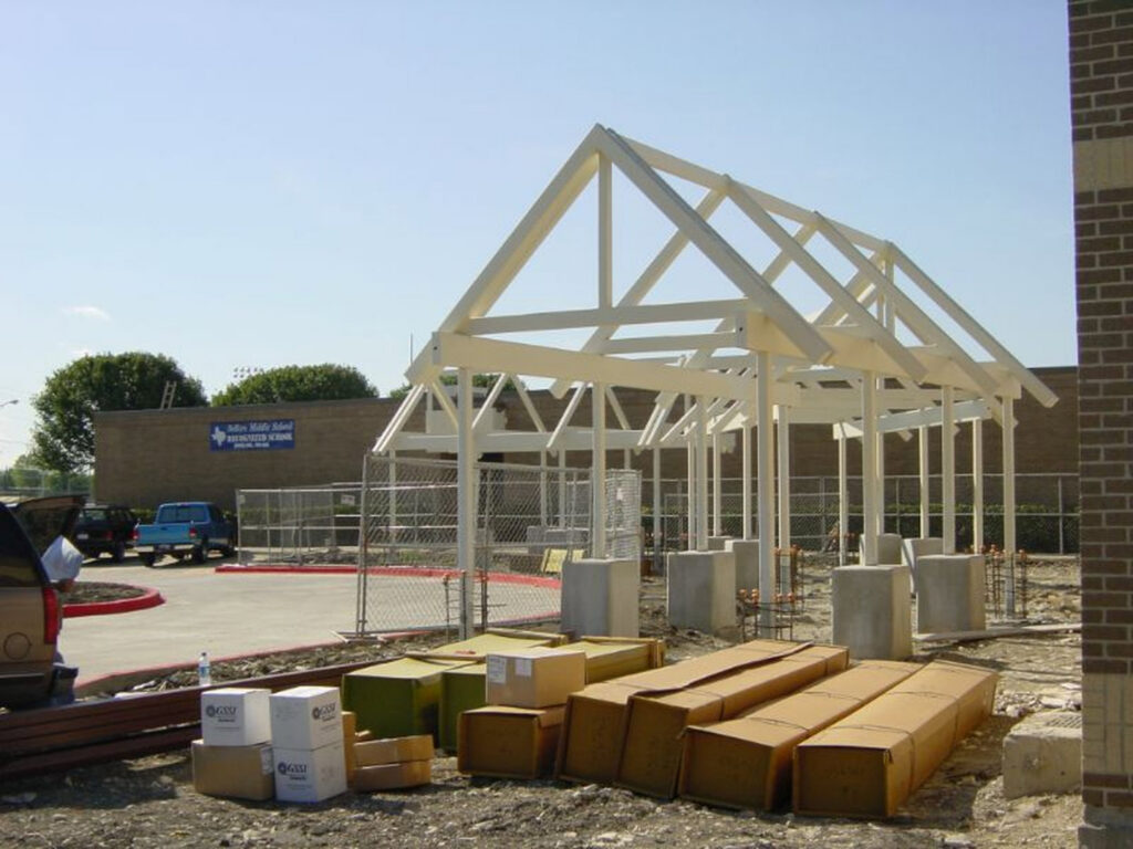 Commercial building frame construction with materials on site by Trident General Contracting in Plano, TX.