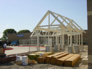 Commercial building frame construction with materials on site by Trident General Contracting in Plano, TX.