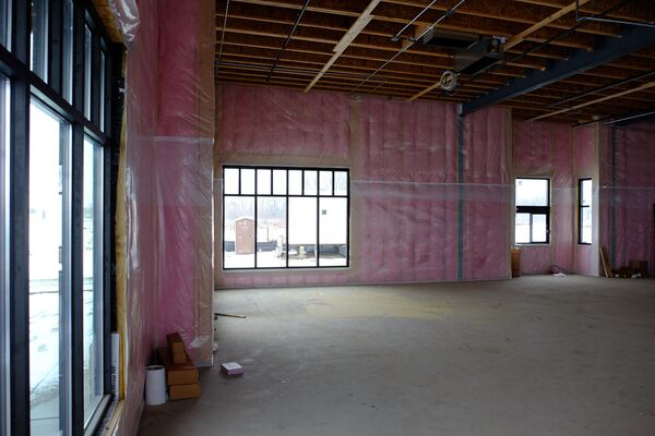 Interior of a commercial building with pink insulation installed on walls by Key Insulation in San Antonio, TX.