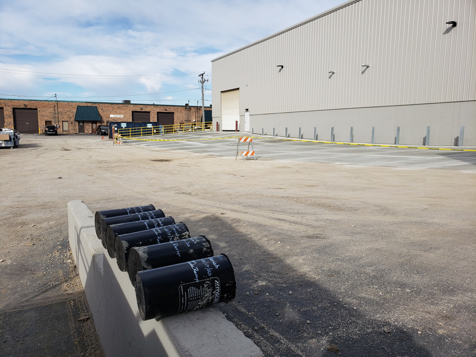 Commercial building with a loading dock area and new pavement, completed by Integrated Building Systems, Inc. in Westmont, IL.