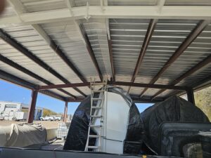 A commercial building under construction with a metal roof and exposed beams, built by M.M. Remodelers in Resaca, GA.