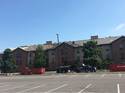 A large commercial building undergoing extensive roof repair and renovation by Elk Building Services in Toledo, OH.