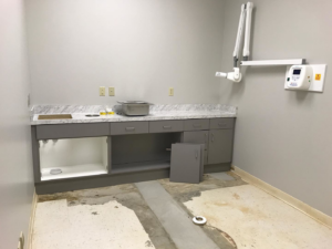 New cabinets installed in a commercial space with an unfinished floor by Savage Construction in Cordova, TN.
