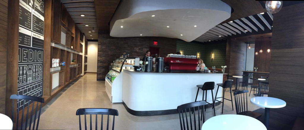 A panoramic view of a modern commercial cafe interior build-out by Drophouse Design in Austin, TX