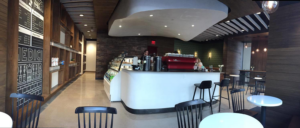 A panoramic view of a modern commercial cafe interior build-out by Drophouse Design in Austin, TX