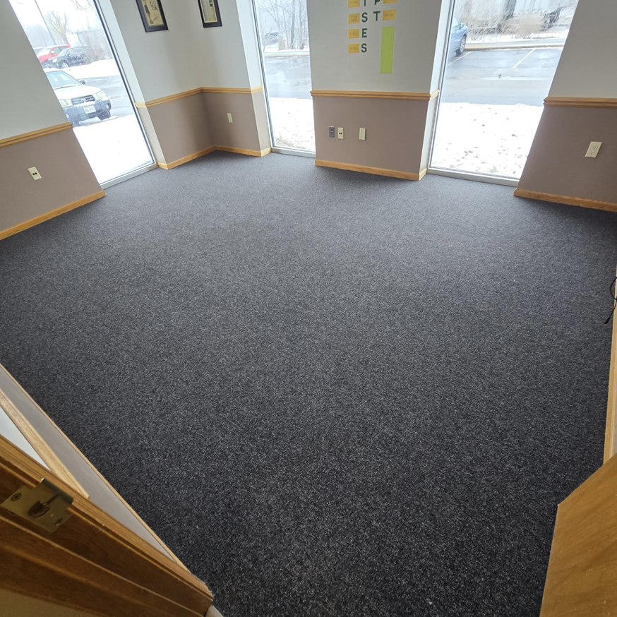 Dark gray commercial carpet installation in an office space by L.A. Floors in Madison, WI.