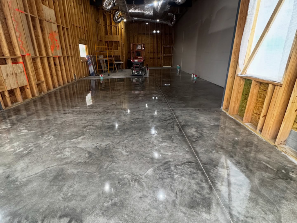A newly installed, shiny grey concrete floor coating in a commercial building by 812 Concrete Coatings in Evansville, IN.