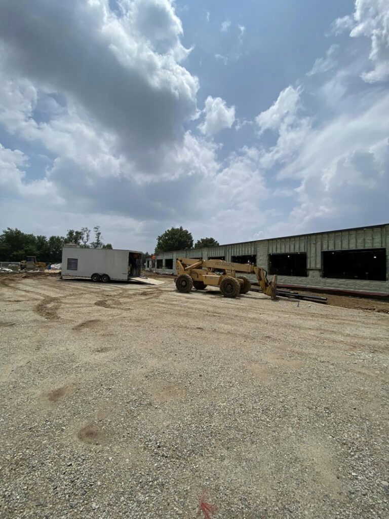 A commercial construction site with heavy equipment and a building under development, managed by Olympus Spray Foam in Philadelphia, PA.