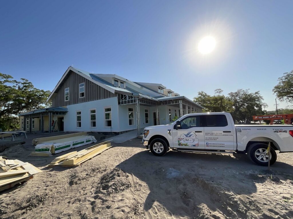 Commercial construction site with a company truck and building materials by M&J Florida Enterprise Llc in Orlando, FL.
