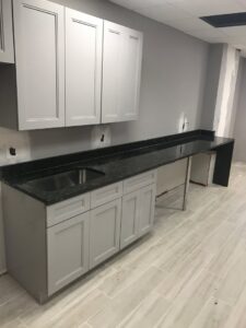A commercial counter and cabinet installation with a sink by BRM Construction in Miami, FL.