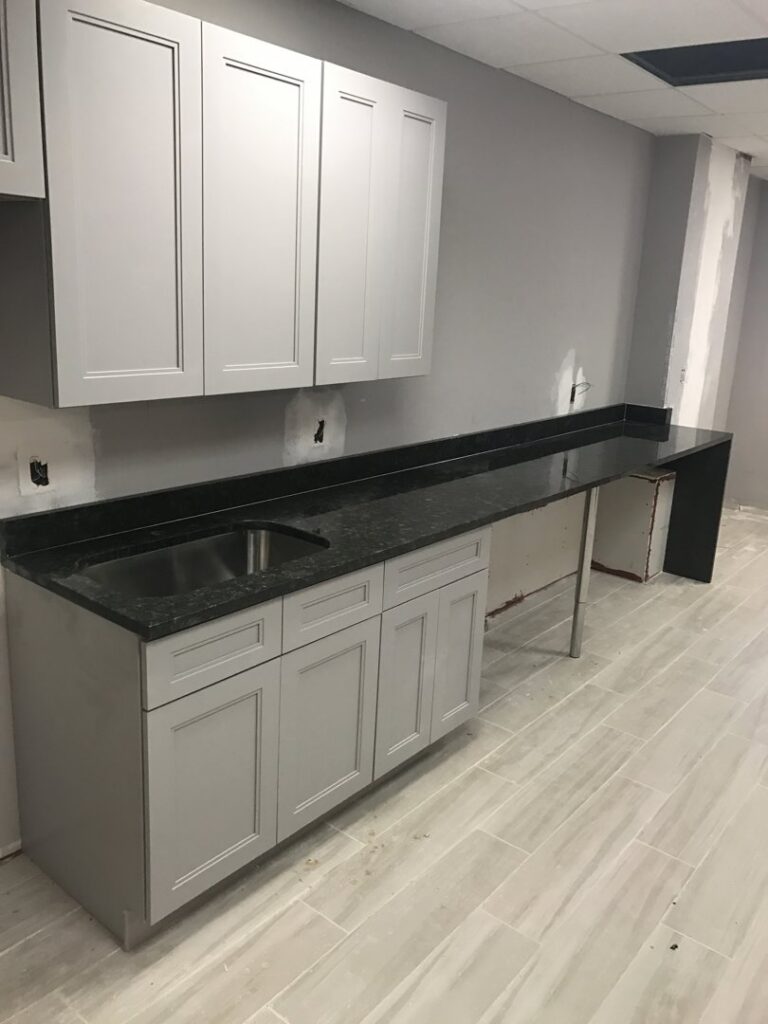 A commercial counter and cabinet installation with a sink by BRM Construction in Miami, FL.