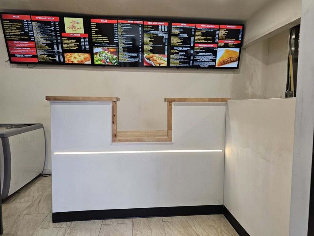 A newly installed commercial counter with menu boards above, completed by Modern Remodel Build & Design in Worcester, MA.