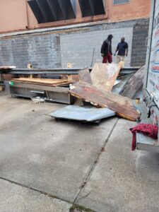 Workers loading commercial debris and scrap for junk removal by Jugganott Recycling, LLC in Orlando, FL.
