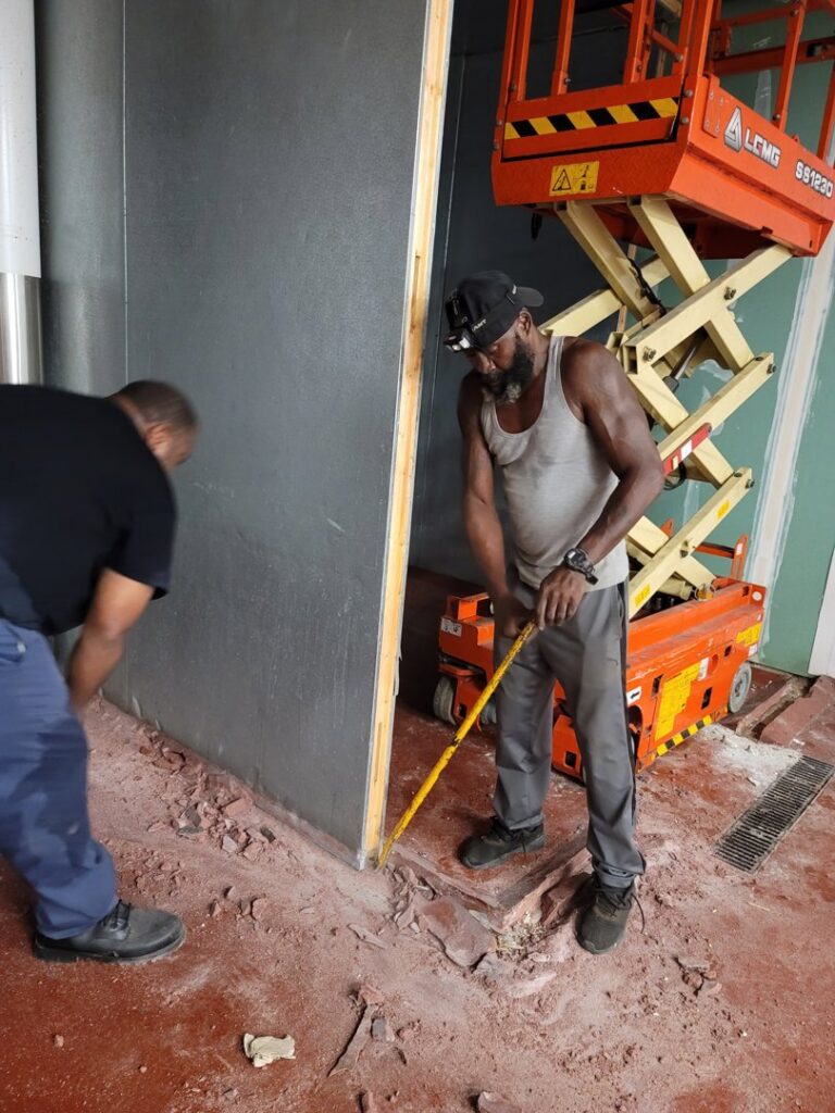 Workers removing debris from a commercial renovation site, a service provided by Jugganott Recycling, LLC in Orlando, FL.