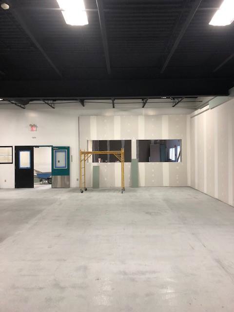 Commercial drywall installation with scaffolding in a large space by Farnsworth Interiors Drywall and Plaster in Akron, OH