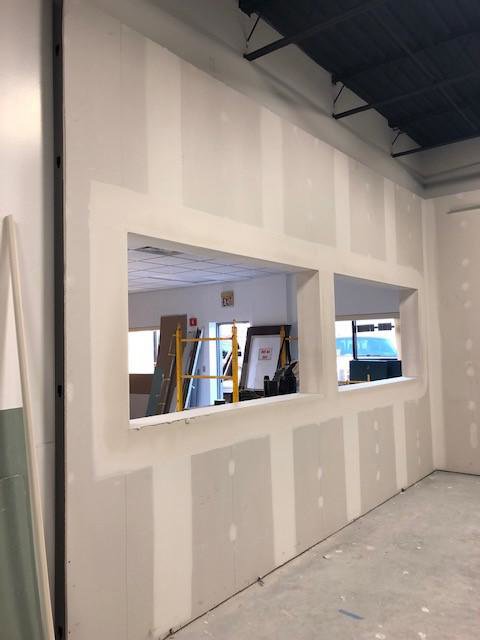 Commercial drywall installation with window cutouts in a new space by Farnsworth Interiors Drywall and Plaster in Akron, OH
