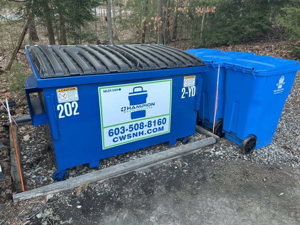 A commercial dumpster and a residential trash bin from Champion Waste Services in Londonderry, NH.
