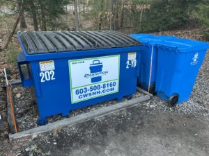 A commercial dumpster and a residential trash bin from Champion Waste Services in Londonderry, NH.