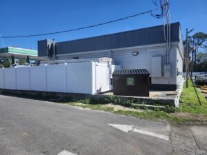 A brown commercial dumpster from Community Disposal placed outside a business for waste management in Jacksonville, FL.