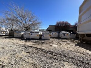 Multiple commercial dumpsters and bins in the yard of Nevada Recycling and Salvage in Reno, NV.