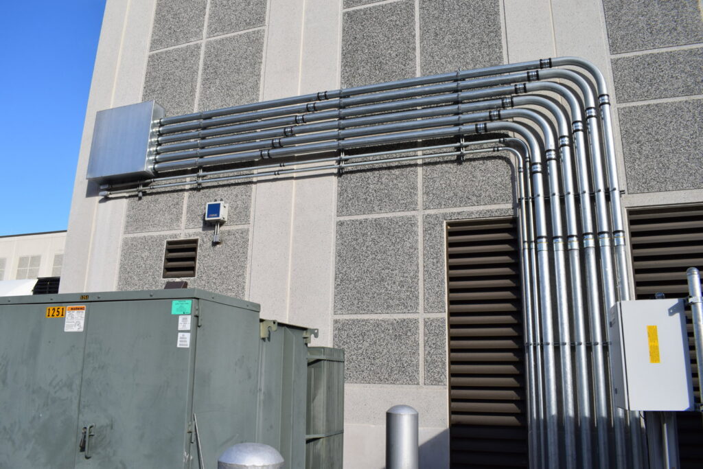 Commercial electrical conduit installation on a building exterior by Commonwealth Electrical Technologies in Worcester, MA