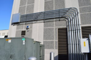 Commercial electrical conduit installation on a building exterior by Commonwealth Electrical Technologies in Worcester, MA