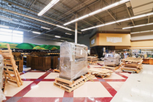 New commercial equipment on pallets awaiting installation in a large space, handled by BFC Construction in Tacoma, WA.