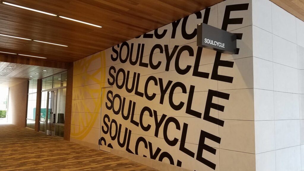 Commercial exterior wall with "SOULCYCLE" branding, indicating a finishing or installation project by T-Byrd Painting in Austin, TX