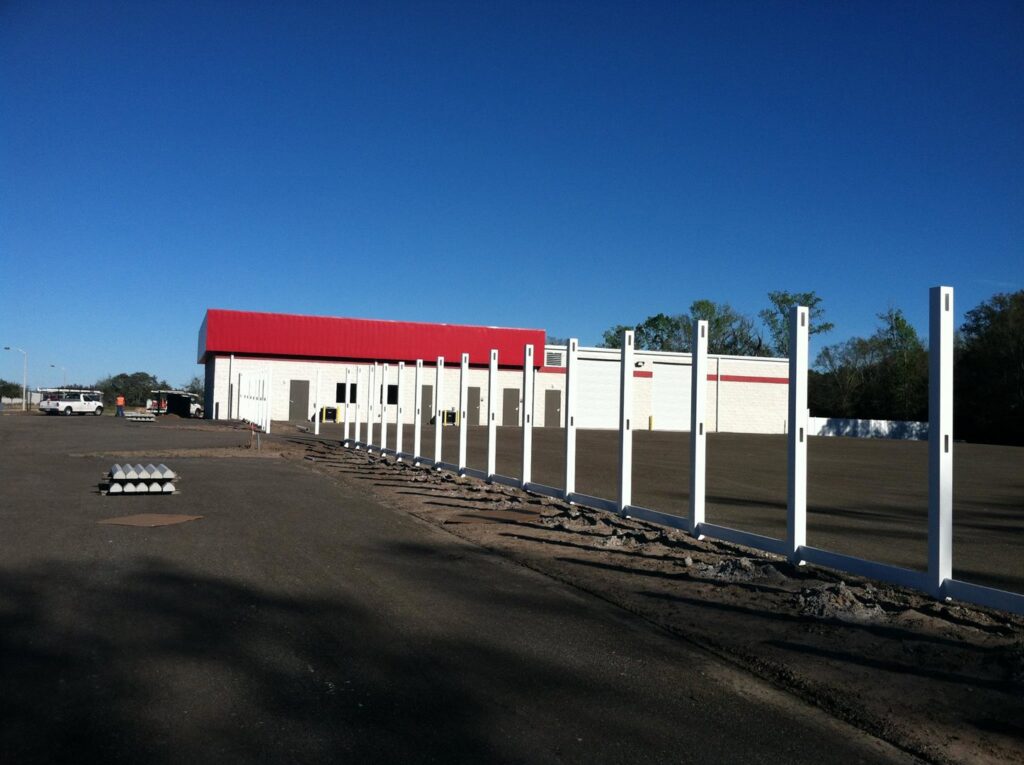 Fence posts being installed in front of a commercial building by Keeler Fence in New Port Richey, FL.