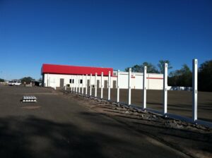 Fence posts being installed in front of a commercial building by Keeler Fence in New Port Richey, FL.