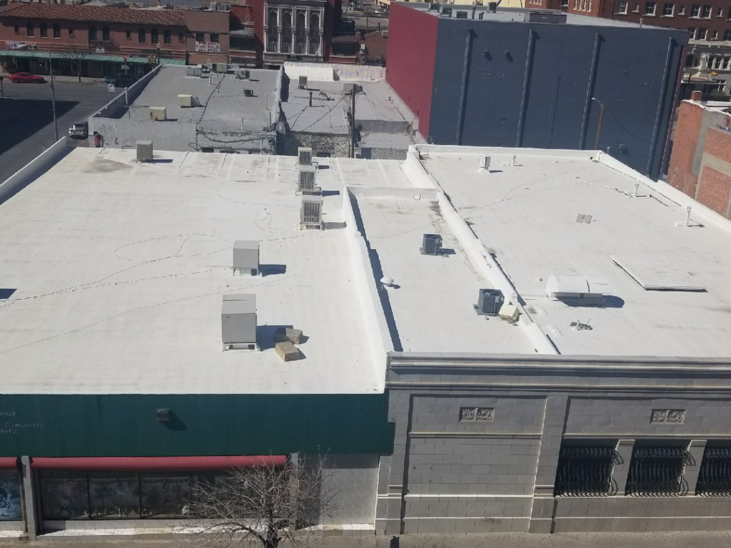 An aerial view of a commercial flat roof with multiple HVAC units, completed by Campos & Son Roofing and Construction in El Paso, TX
