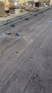 Commercial flat roof inspection and maintenance by Painting Professionals, Inc. in Houston, TX
