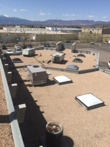 A commercial flat roof with multiple skylights and HVAC units, serviced by Elite Roofing Colorado Springs, CO.