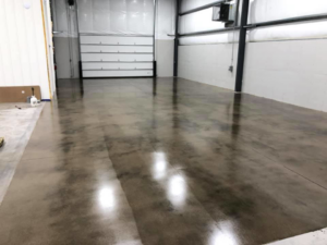 A polished concrete floor in a commercial garage space by Kentucky Decorative Concrete in Nicholasville, KY.