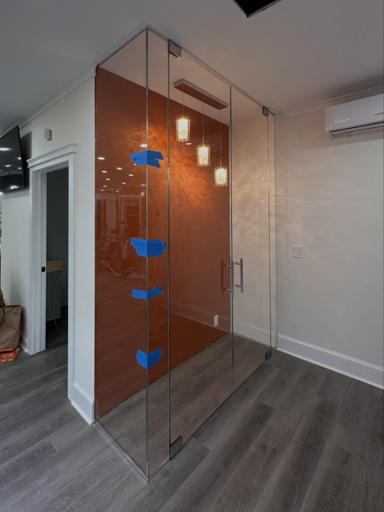 A commercial glass enclosure being installed, showcasing handyman services by MW Glass in Stamford, CT.