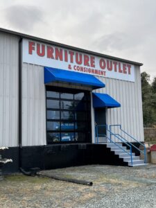 Commercial glass garage door installed on a furniture outlet by Total Garage Works in Indian Trail, NC.