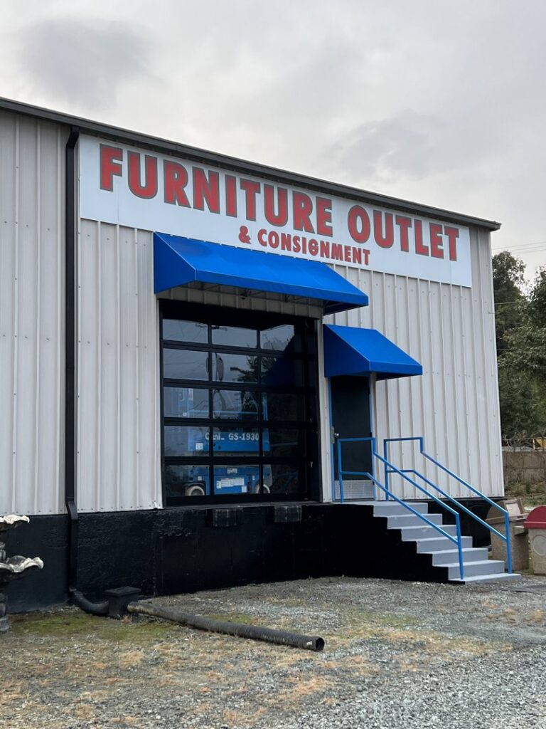 Commercial glass garage door installed on a furniture outlet by Total Garage Works in Indian Trail, NC.