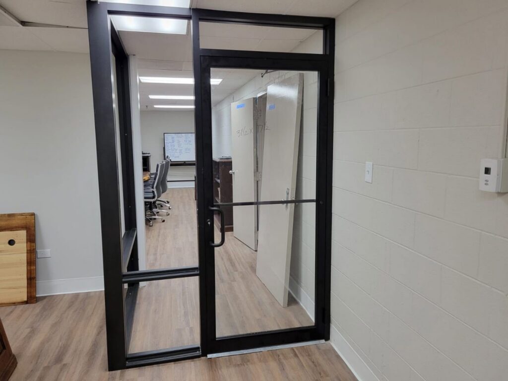 A new commercial glass and metal door installation in an office setting by Keeler Construction Group Inc. in Blue Island, IL.