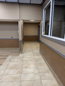 A renovated commercial hallway with new tile flooring and finished walls by P.G.R Construction,Inc in Rehoboth, MA.