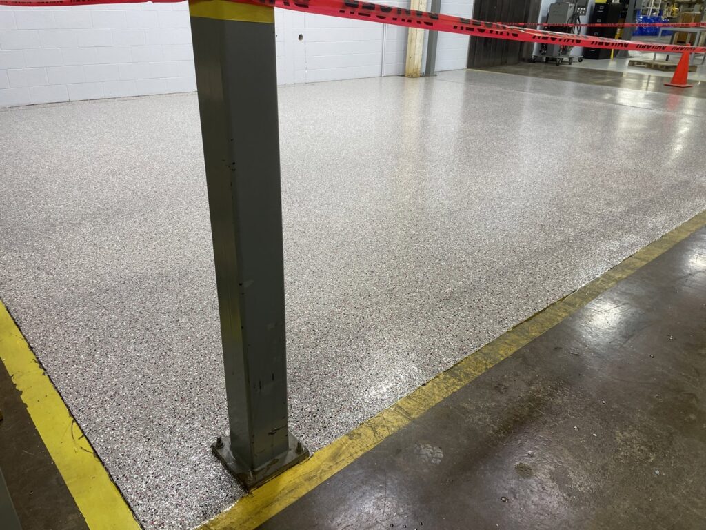 A commercial or industrial floor with a new, durable coating and safety lines by Egli Coating Solutions in Evansville, IN.