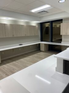 A spacious completed commercial interior with multiple workstations and cabinetry by Belair Inc. in Saint Cloud, FL