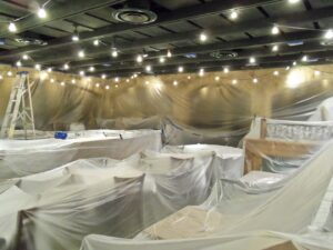 Commercial interior room fully prepped with plastic sheeting for painting by Vico Painting Contractors in Hialeah, FL