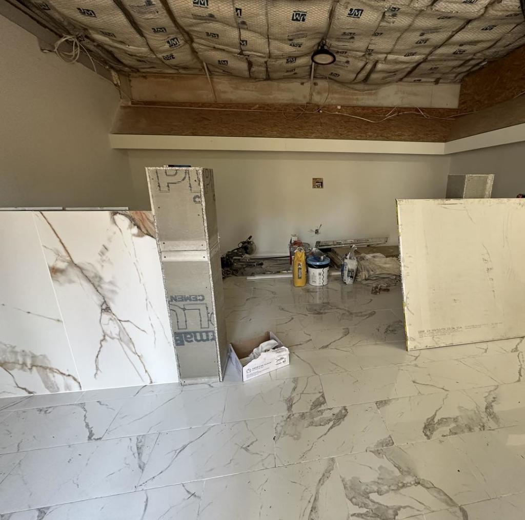 Commercial interior renovation in progress with exposed ceiling and construction materials by Carolina DR & Roofing in Raleigh, NC.