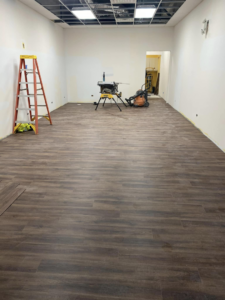 Commercial interior renovation in progress with new flooring and tools by Strom Contracting LLC in Crystal Lake, IL.