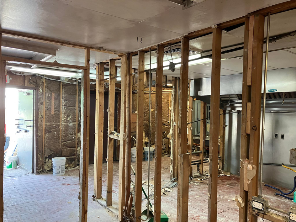 A wide view of a commercial interior renovation project with exposed framing by JB Renovations in Houston, TX.