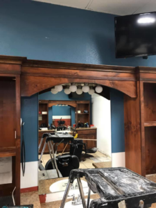 Commercial interior renovation showing a large mirror and light fixture installation by Celano Construction in Mesa, AZ