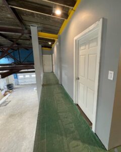 An interior commercial renovation project showing new walls and a protected walkway by Creative Touch Renovations LLC in Harrisburg, PA.